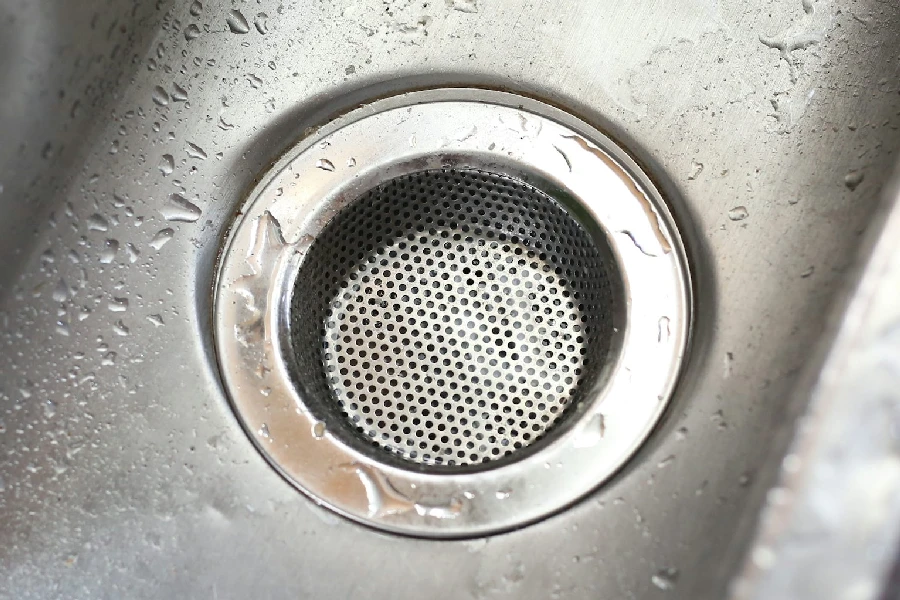 a stainless steel sink with a strainer in it