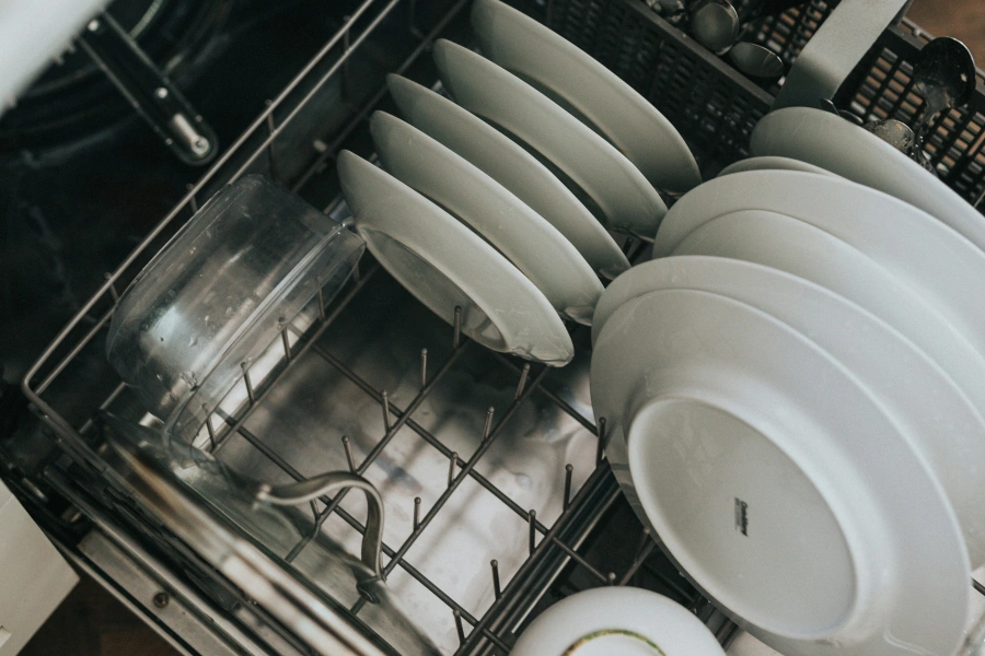 white ceramic plates inside a dishwasher